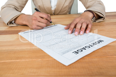 Mid section of businesswoman filling mortgage contract form