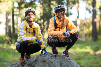 Portrait of biker couple smiling in forest