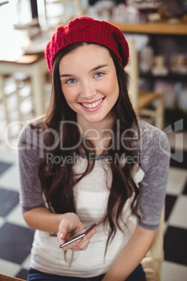 Portrait of smiling woman using mobile phone