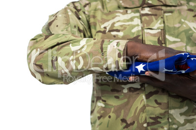 Mid section of soldier holding an american flag