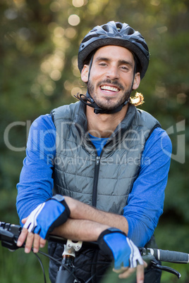 Portrait of male biker with mountain bike