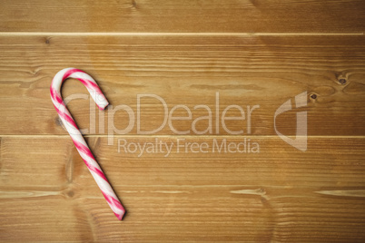 Candy cane on wooden table