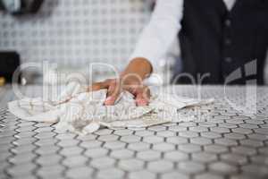 Waiter cleaning bar counter