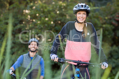 Biker couple cycling in countryside Biker couple cycling in countryside