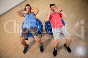 Men exercising on exercise ball