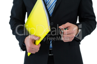 Mid section of businessman holding keys