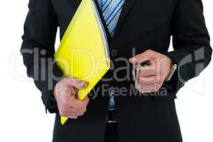 Mid section of businessman holding keys