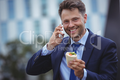 Portrait of handsome businessman talking on mobile phone