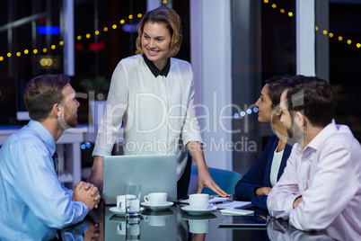 Businesswoman interacting with her colleagues