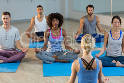 Instructor taking yoga class