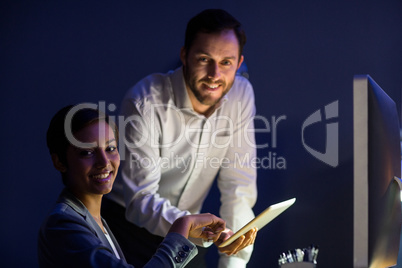 Businesswoman and businessman using digital tablet