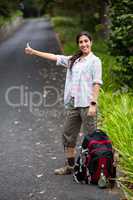 Woman hitchhiking on countryside road