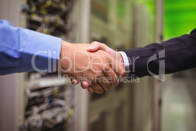 Close-up of technicians shaking hands