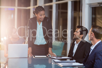 Businesswoman interacting with coworkers in a meeting in the conference room