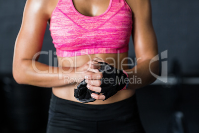 Female athlete removing gloves