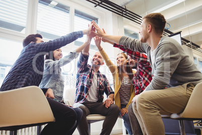 Low angle view of creative business people giving high-five