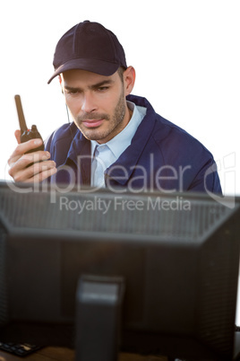 Close-up of security officer talking on walkie-talkie