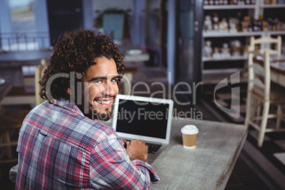Portrait of man smiling while using laptop Portrait of man smiling while using laptop