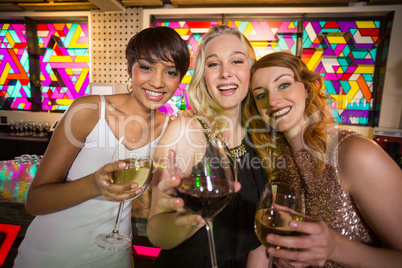 Three smiling friend having glass of champagne