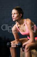 Woman exercising with dumbbell in gym