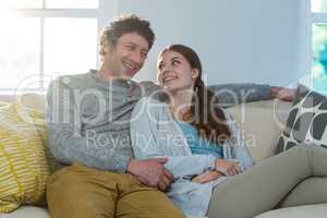 Couple sitting together on sofa