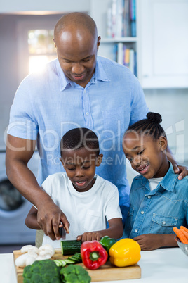 Father preparing food with their children