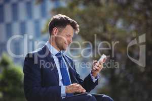 Handsome businessman using mobile phone