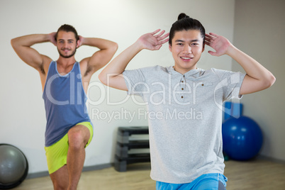 Smiling two men doing aerobic exercise