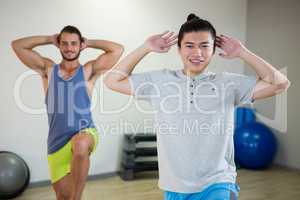 Smiling two men doing aerobic exercise