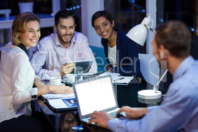 Businesspeople interacting with each other in office