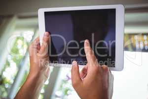 Close-up of hand using digital tablet