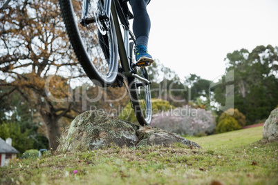 Male mountain biker riding bicycle in the forest