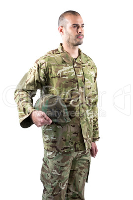 Confident soldier standing with a helmet