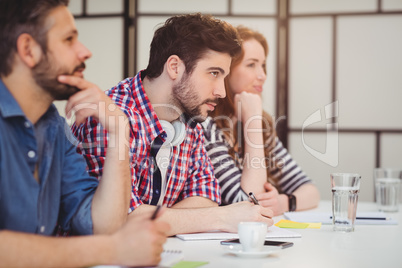 Coworkers sitting at desk in creative office