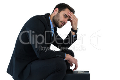 Depressed businessman sitting on steps