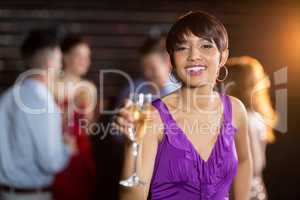 Portrait of young woman holding a glass of champagne