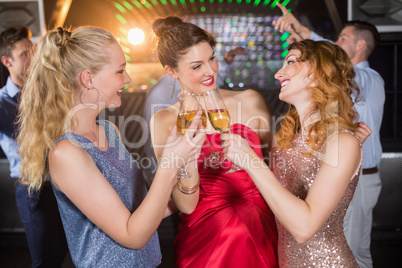 Female friends toasting glasses of champagne