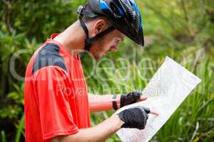 Male cyclist looking at map