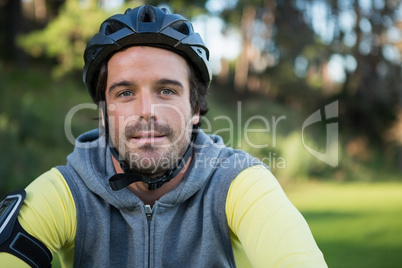 Portrait of male mountain biker riding bicycle in the forest