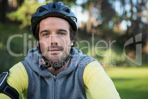 Portrait of male mountain biker riding bicycle in the forest