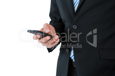 Mid section of businessman text messaging on mobile phone