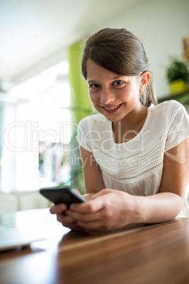 Girl using mobile phone in the living room