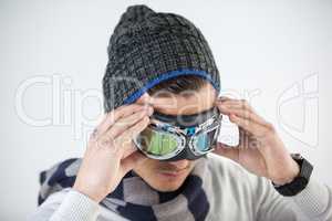 Man in winter clothing wearing aviator goggles