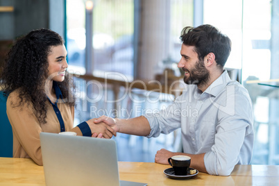 Couple shaking hands in caf�© Couple shaking hands in caf�©