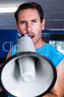 Portrait of fitness instructor using megaphone