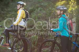 Biker couple looking at a view in forest