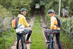 Biker couple with mountain bike in countryside track