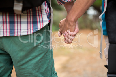 Close-up of hiker couple holding hands