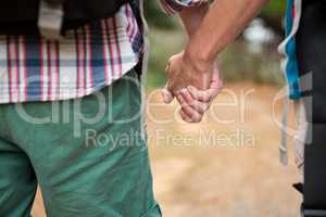 Close-up of hiker couple holding hands