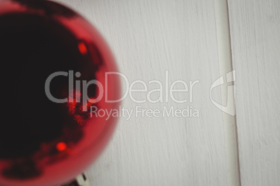 Red christmas bauble on wooden table